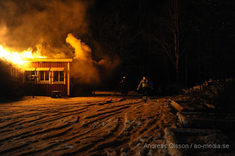 _DSC5591.JPG - Vid 3 tiden larmades räddningstjänsten från perstorp och hässleholm samt polis och ambulans till en villabrand i Ebbarp utanför Perstorp. När räddningstjänsten kom fram var villan redan övertänd. Perstorps släckbil gled av den smala vägen upp till villan och blockerade vägen så man fick dra slang ett par hundra meter fram till villan. En person fanns i villan när branden startade men kunde själv ta sig ut. Man misstänker att branden kan ha starta i en öppen spis eller i skorstenen.